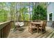 Wooden deck with outdoor seating, a swing, and a view of the surrounding wooded area at 3522 Evans Ridge Trl, Atlanta, GA 30340