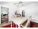 Bright dining room featuring contemporary lighting, white walls, and hardwood floors with a large red area rug at 3522 Evans Ridge Trl, Atlanta, GA 30340