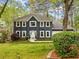 Charming two-story home featuring beautiful landscaping, a well-manicured lawn, and neutral trim against dark siding at 3522 Evans Ridge Trl, Atlanta, GA 30340