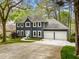 Beautifully landscaped home with a long driveway, two-car garage and classic architectural details at 3522 Evans Ridge Trl, Atlanta, GA 30340
