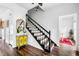 Foyer area featuring black staircase, hardwood floors, and yellow accent decor at 3522 Evans Ridge Trl, Atlanta, GA 30340