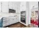 Bright kitchen featuring white cabinets, stainless steel appliances, and a view of the dining room at 3522 Evans Ridge Trl, Atlanta, GA 30340