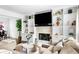 Comfortable living room featuring a stone fireplace and custom built-ins at 3522 Evans Ridge Trl, Atlanta, GA 30340