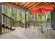 Outdoor patio with seating, wood flooring, and an umbrella, providing a comfortable area for relaxation at 3522 Evans Ridge Trl, Atlanta, GA 30340