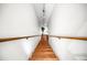 View down the wood staircase with white walls leading to the lower level, enhanced by a small plant at 3522 Evans Ridge Trl, Atlanta, GA 30340