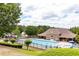 Community pool, playground and clubhouse with trees in the background at 436 Crestmont Ln, Canton, GA 30114