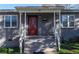 Inviting front porch with white railings and supports, leading to a striking red front door with glass features at 60 Cleveland Se St, Atlanta, GA 30316