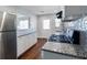 Modern kitchen with granite countertops, tile backsplash, stainless steel appliances and dark stained hardwood floors at 60 Cleveland Se St, Atlanta, GA 30316