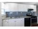 Well-lit kitchen features stainless steel appliances, granite counters, and white cabinetry at 60 Cleveland Se St, Atlanta, GA 30316