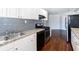 Well-lit kitchen features stainless steel appliances, granite counters, and white cabinetry at 60 Cleveland Se St, Atlanta, GA 30316