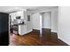 Modern kitchen with stainless steel appliances, granite countertops, tile backsplash, and dark-stained hardwood floors at 60 Cleveland Se St, Atlanta, GA 30316