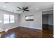 Spacious living room with shiny hardwood floors, ceiling fan, and view into the kitchen at 60 Cleveland Se St, Atlanta, GA 30316