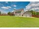 Backyard view featuring a deck, patio, and basketball area, enclosed by a wooden fence at 981 Golden Meadows Ln, Loganville, GA 30052