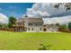 Large, grassy backyard featuring a deck, patio, and basketball court area at 981 Golden Meadows Ln, Loganville, GA 30052