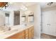 Bathroom featuring a double sink vanity and a large mirror, complemented by modern fixtures and a separate shower area at 981 Golden Meadows Ln, Loganville, GA 30052