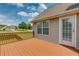 Side view of the wooden deck area with door, window, and brown railings overlooking the yard at 981 Golden Meadows Ln, Loganville, GA 30052