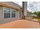 Upper wooden deck has a door and overlooks a lower patio and backyard at 981 Golden Meadows Ln, Loganville, GA 30052