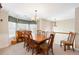 Open concept dining room with wooden table set, chandelier lighting, and access to the second floor at 981 Golden Meadows Ln, Loganville, GA 30052