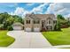 Charming brick home with a three car garage and well maintained lawn at 981 Golden Meadows Ln, Loganville, GA 30052