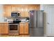 Updated kitchen featuring stainless steel appliances, wood cabinets, and hardwood floors at 981 Golden Meadows Ln, Loganville, GA 30052