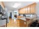 Open kitchen featuring breakfast bar, wood cabinets, hardwood floors, and stainless steel appliances at 981 Golden Meadows Ln, Loganville, GA 30052