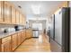 Long kitchen with stainless steel appliances, wood cabinets, and hardwood floors at 981 Golden Meadows Ln, Loganville, GA 30052