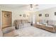 Comfortable living room featuring plush sofas, a ceiling fan, and neutral decor at 981 Golden Meadows Ln, Loganville, GA 30052
