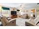 Relaxing living room with comfortable seating, bright windows and view to the kitchen at 981 Golden Meadows Ln, Loganville, GA 30052