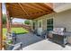 Covered patio has a view of the lawn, seating, and grilling area at 981 Golden Meadows Ln, Loganville, GA 30052