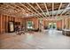 Unfinished basement with exposed framing, workout area, and outdoor access at 1155 Mcconnell Dr, Decatur, GA 30033
