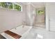 Bathroom with large glass shower and soaking tub, enhanced by a large window offering natural light at 1155 Mcconnell Dr, Decatur, GA 30033