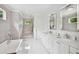 Elegant bathroom with a walk-in shower, a modern soaking tub, and white cabinetry, blending style with functionality at 1155 Mcconnell Dr, Decatur, GA 30033