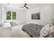 Bright bedroom with a large window, ceiling fan, and a black and white striped bedspread at 1155 Mcconnell Dr, Decatur, GA 30033