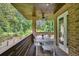 Outdoor deck with dining area, ceiling fan, and a view of surrounding lush greenery at 1155 Mcconnell Dr, Decatur, GA 30033
