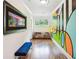 Hallway showcasing colorful mural art, natural light from the window, and hardwood flooring that adds charm at 1155 Mcconnell Dr, Decatur, GA 30033