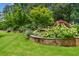 Landscaped yard featuring brick retaining wall and beautiful flowerbeds at 1155 Mcconnell Dr, Decatur, GA 30033