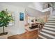 Open concept living room showcasing a soaring ceiling, hardwood floors and modern staircase at 1155 Mcconnell Dr, Decatur, GA 30033