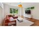 Cozy living room area with hardwood floors and a modern light fixture at 1155 Mcconnell Dr, Decatur, GA 30033