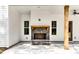 Covered back porch featuring a stone fireplace, stained wooden beam, and ceiling fan at 1687 Harmony Rd, Temple, GA 30179
