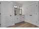 Bathroom featuring double vanities, linen closet and updated lighting fixtures at 1687 Harmony Rd, Temple, GA 30179