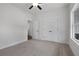 Bedroom featuring neutral carpet, double door closet, and an ensuite bathroom and ceiling fan at 1687 Harmony Rd, Temple, GA 30179