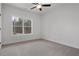 Bright bedroom featuring neutral carpet, a large window providing natural light and white trim at 1687 Harmony Rd, Temple, GA 30179