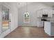 Dining area off the kitchen with a window view, modern lighting, and access to the outdoors at 1687 Harmony Rd, Temple, GA 30179