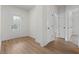 Bright entryway with wood-look flooring, white walls, and a glass-paneled front door leading to the outdoors at 1687 Harmony Rd, Temple, GA 30179