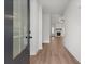 Bright entryway showcasing wood floors and a view into the living room with a fireplace at 1687 Harmony Rd, Temple, GA 30179
