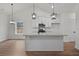 Modern kitchen with white cabinets, granite countertops, stainless steel appliances, and a kitchen island with seating at 1687 Harmony Rd, Temple, GA 30179