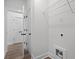 Hallway with view of laundry room featuring wire shelving and hookups at 1687 Harmony Rd, Temple, GA 30179