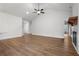 Open living room with a ceiling fan, vaulted ceiling, light-colored plank floors, and a fireplace at 1687 Harmony Rd, Temple, GA 30179
