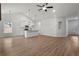 Open-concept living room boasts hardwood floors and a kitchen with stainless steel appliances and an island at 1687 Harmony Rd, Temple, GA 30179