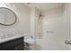 White bathroom features updated vanity, subway tile backsplash, and a shower and tub combo at 172 Forest Nw Ln, Marietta, GA 30064